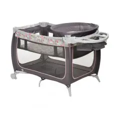 A baby crib with wheels and a tray on top of it.